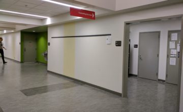 an empty hall with grey flooring