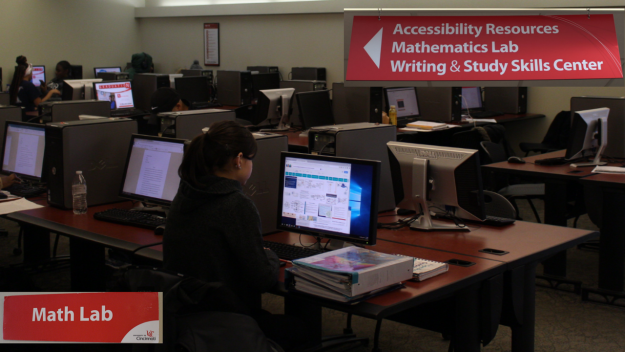 Image of a UCBA computer lab with signs to support services.