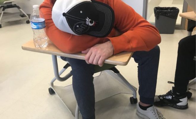 A student resting his head on his desk