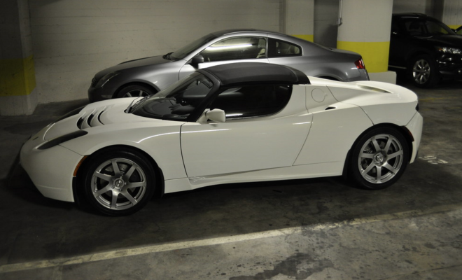 A white Tesla in a parking garage