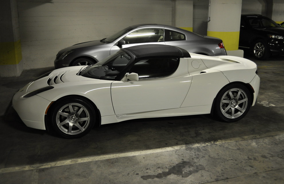 A white Tesla in a parking garage