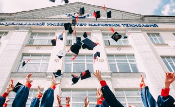 Graduating class throws caps in air