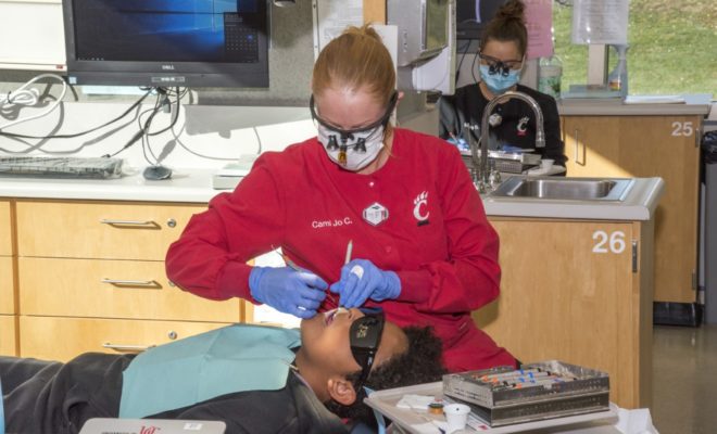 dental hygiene student treats patient
