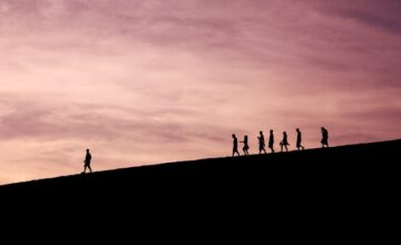 Silhouette of people on a hill